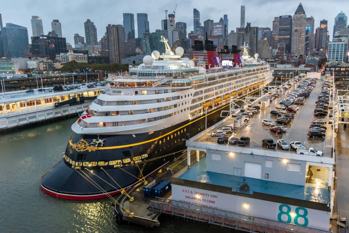 Cruise ship docked at Manhattan Cruise Terminal Pier 88 with the Midtown skyline behind it